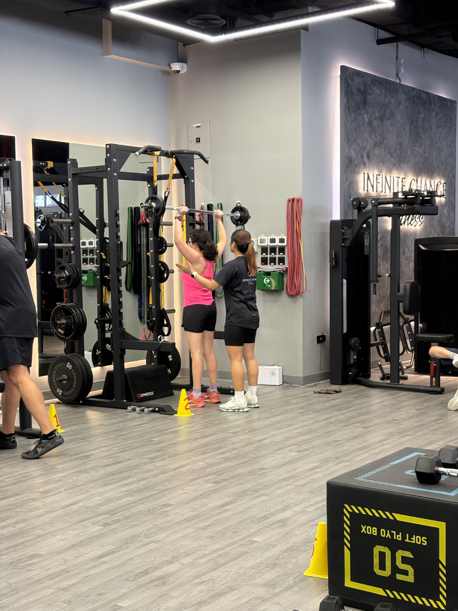 Person beginning a coached strength training session at Infinite Change Fitness in Abu Dhabi